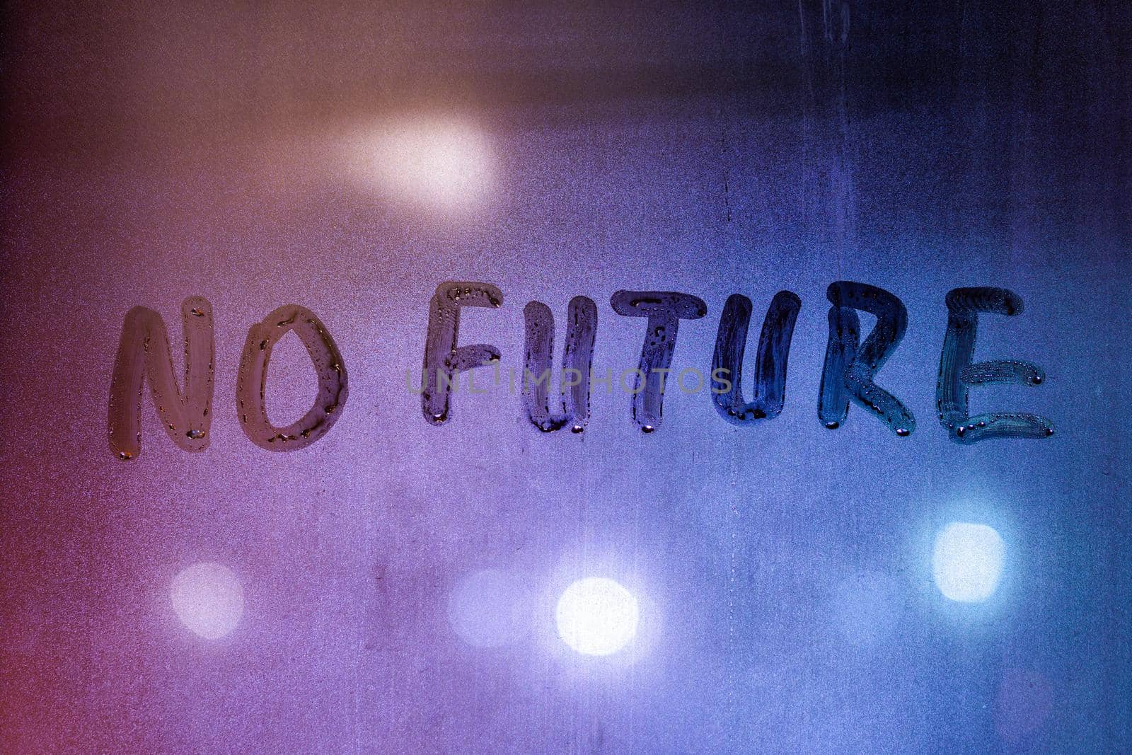 words no future handwritten on night wet window surface, close-up with selective focus