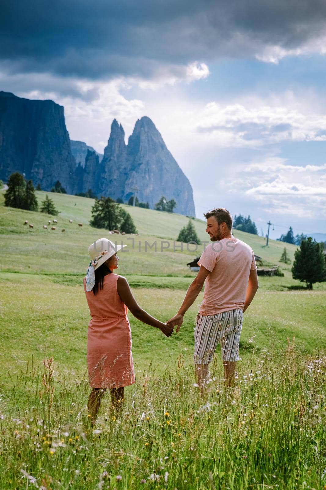 couple men and woman on vacation in the Dolomites Italy,Alpe di Siusi - Seiser Alm Dolomites, Trentino South Tyrol, Italy, by fokkebok