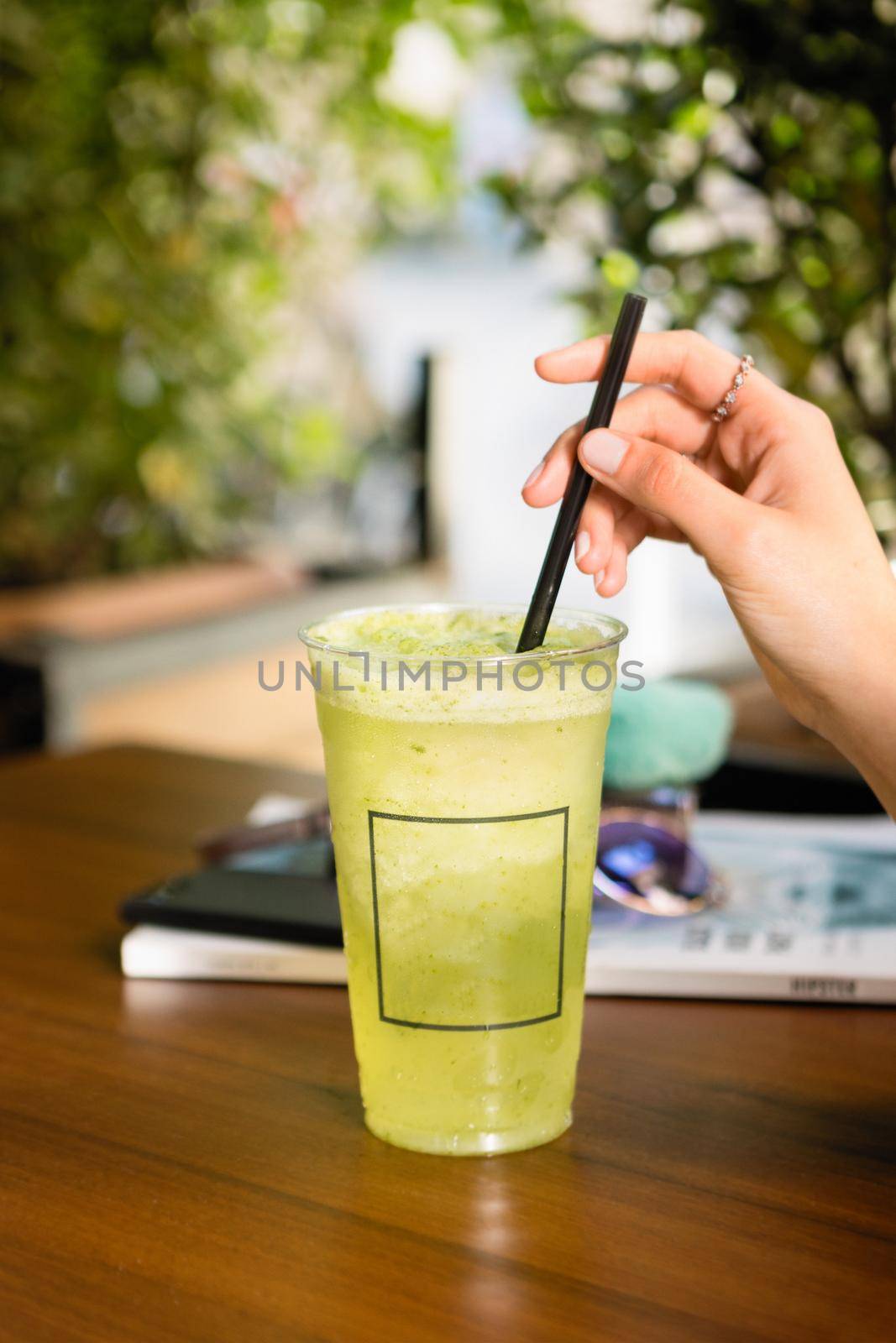 Woman drinking fruit cocktail at a cafe