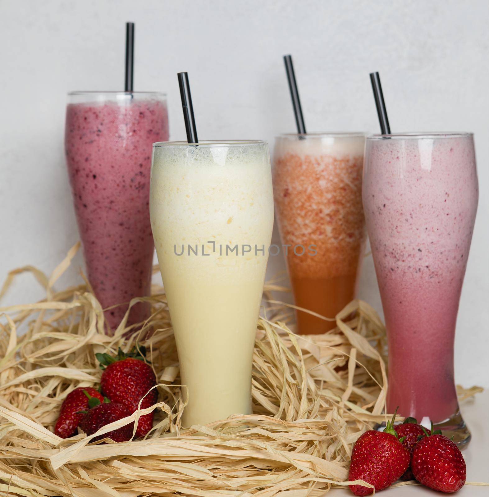Fruit milky cocktails with strawberry on a straw by ferhad