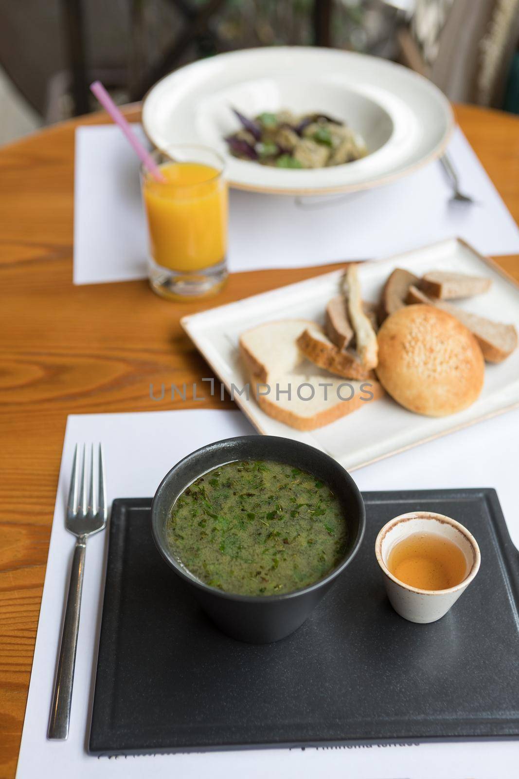 Green soup with sauce on a black plate by ferhad