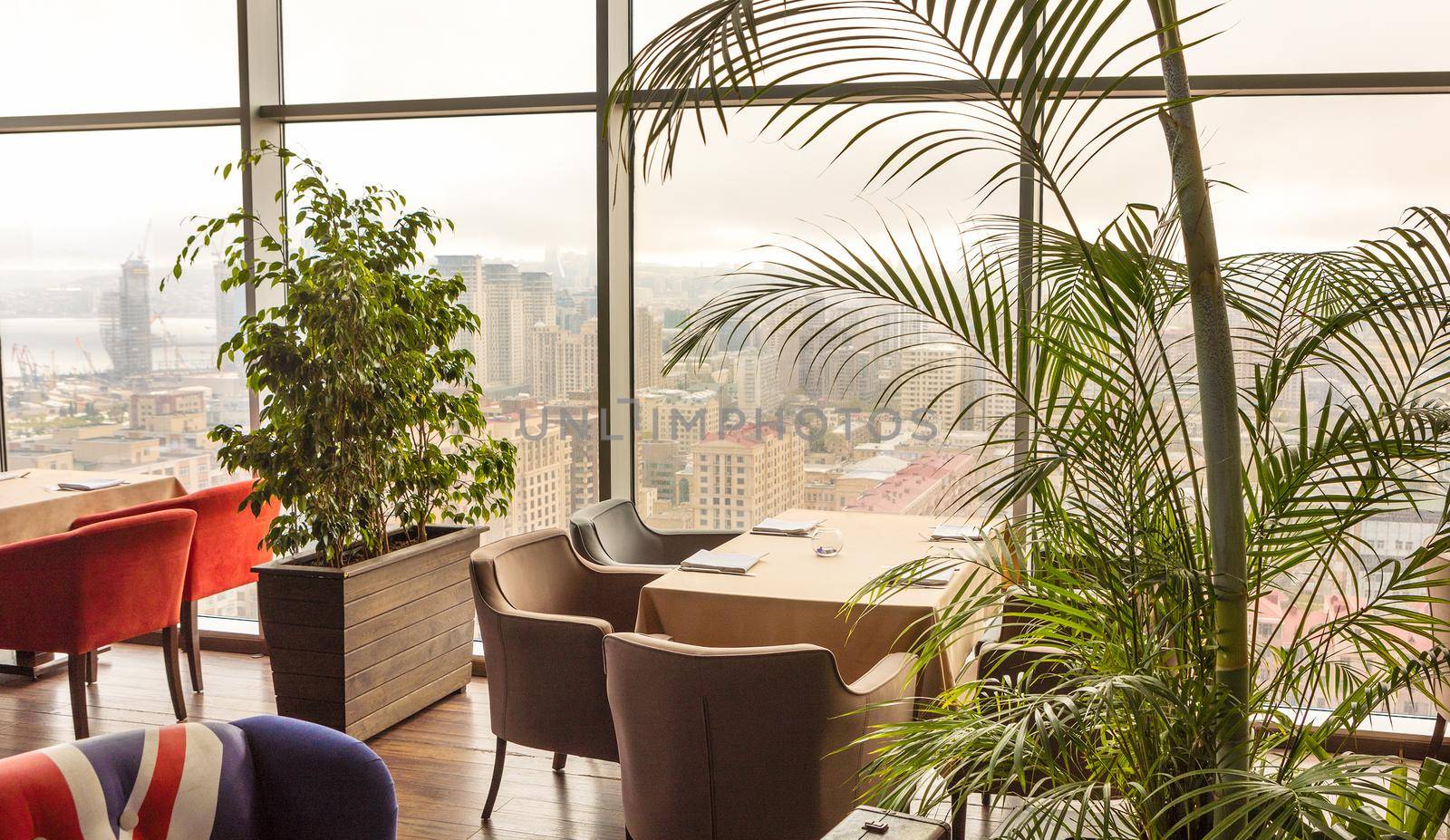 Beautiful restaurant interior with plants, city view by ferhad