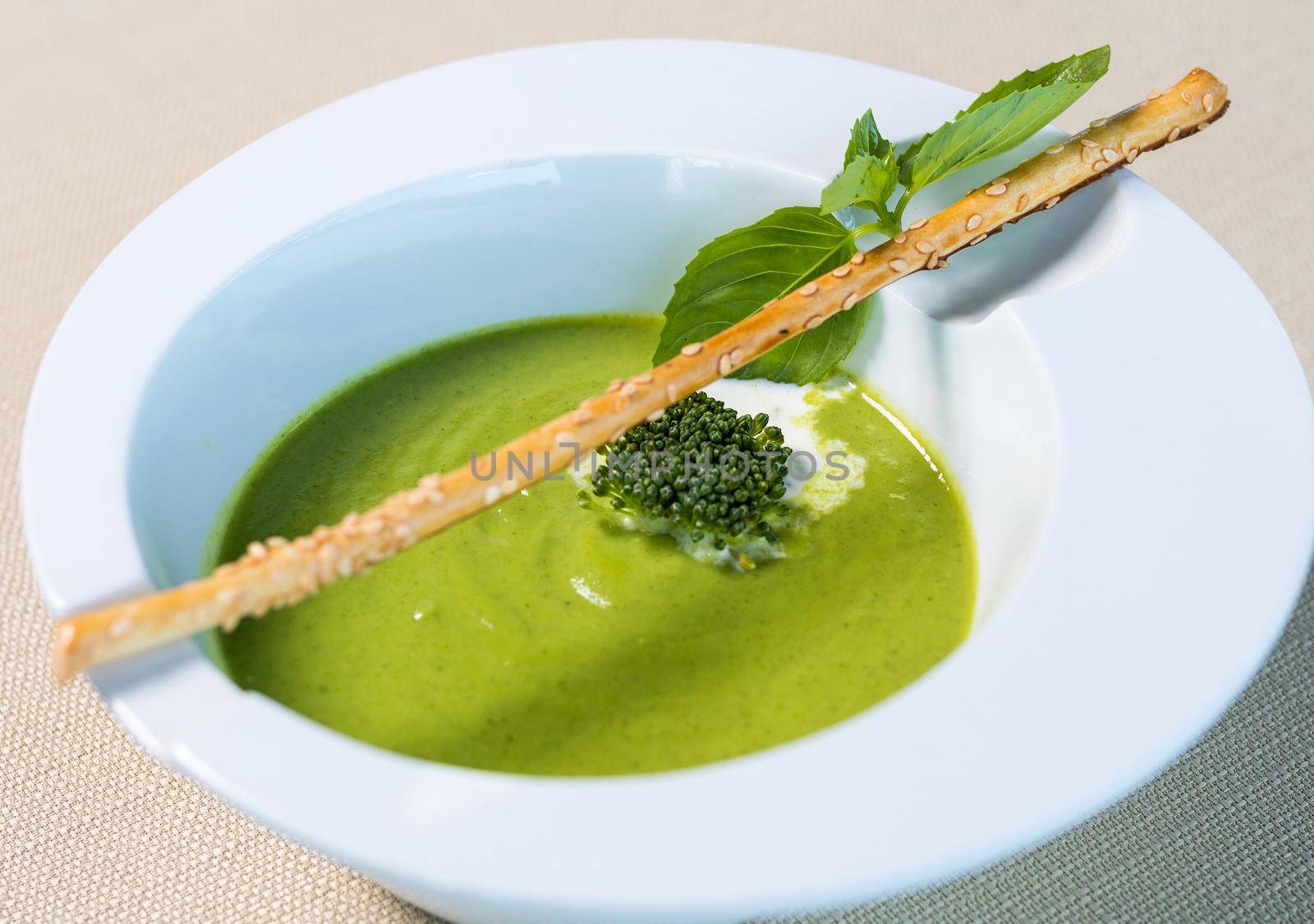 Organic green soup in the white plate close up by ferhad