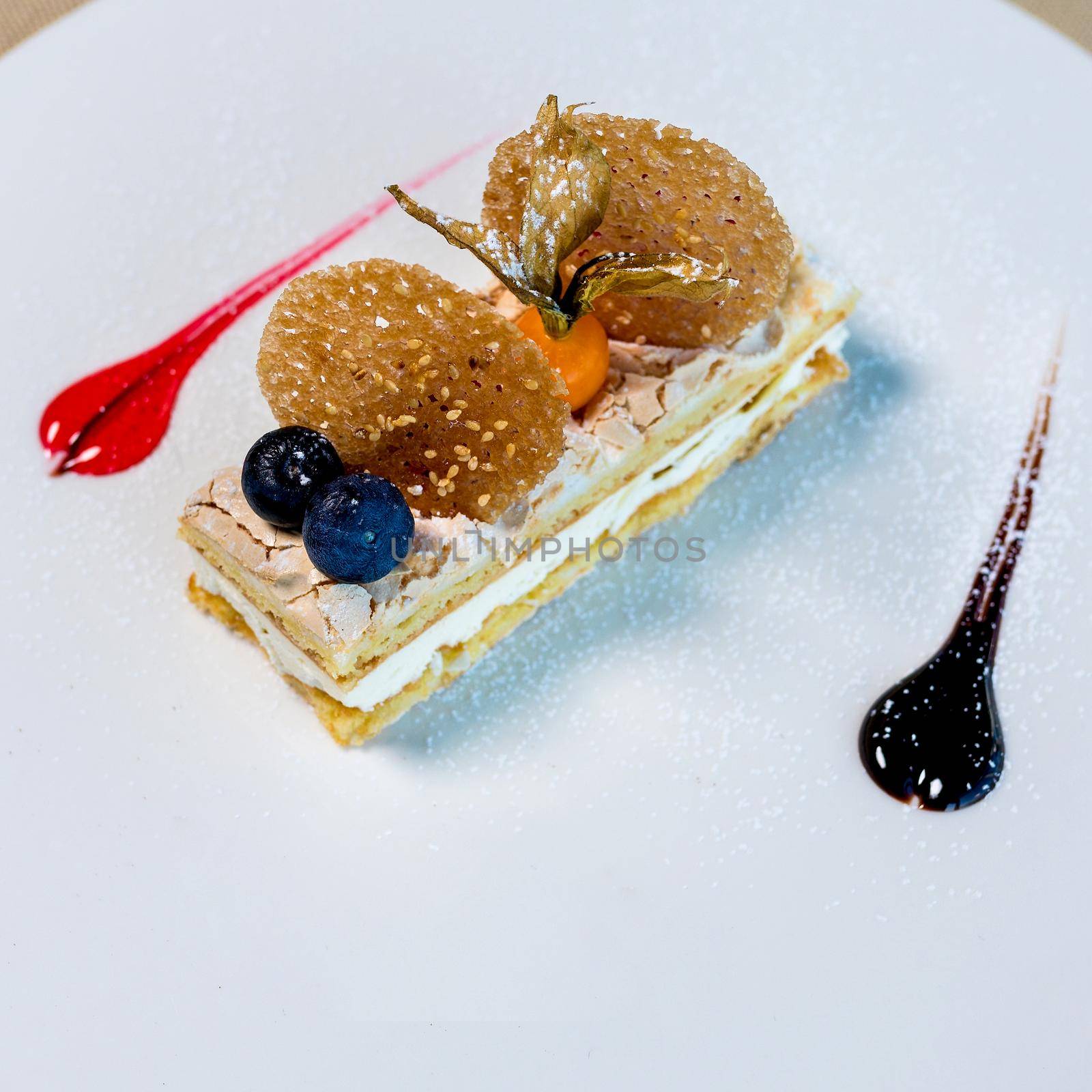 A piece of chocolate cake with mint on the table, close-up