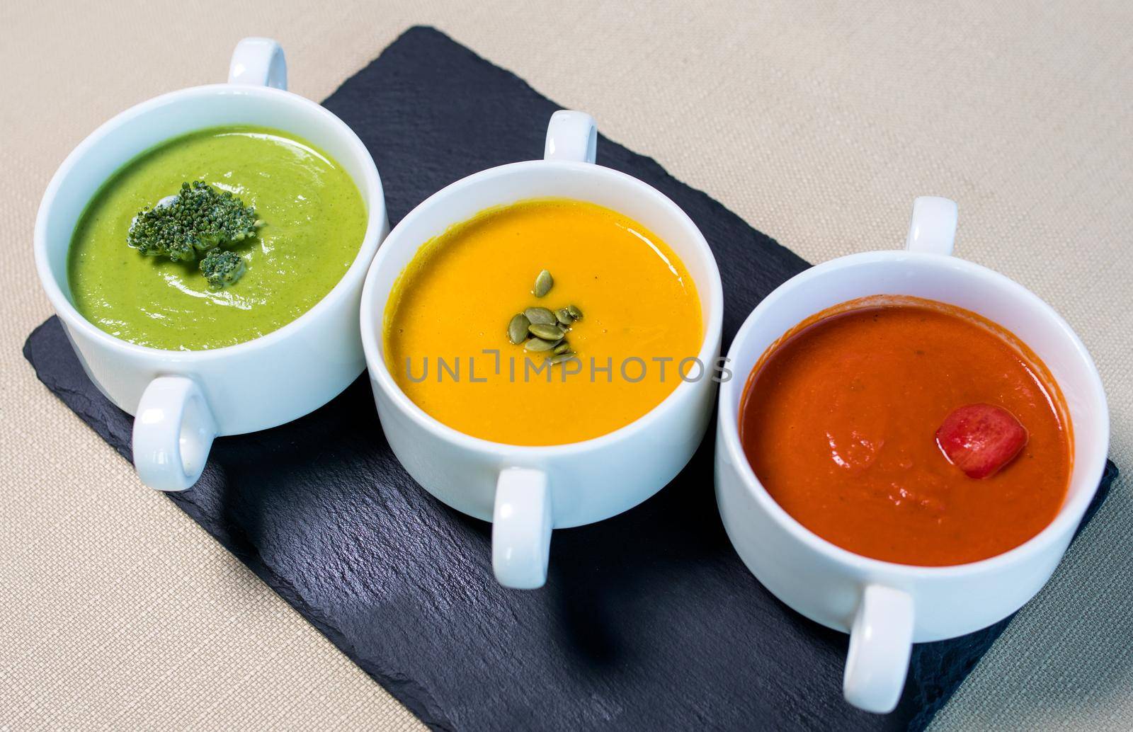 Colorful tasty soups on the black plate by ferhad