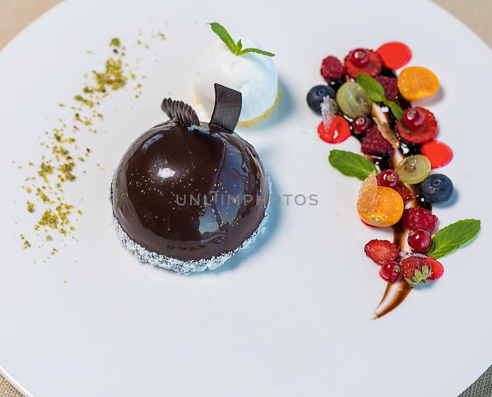 A piece of chocolate cake with mint on the table, close-up by ferhad