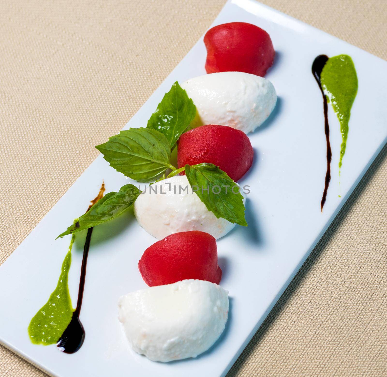 Beautiful ice cream balls with tomato on the white plate by ferhad