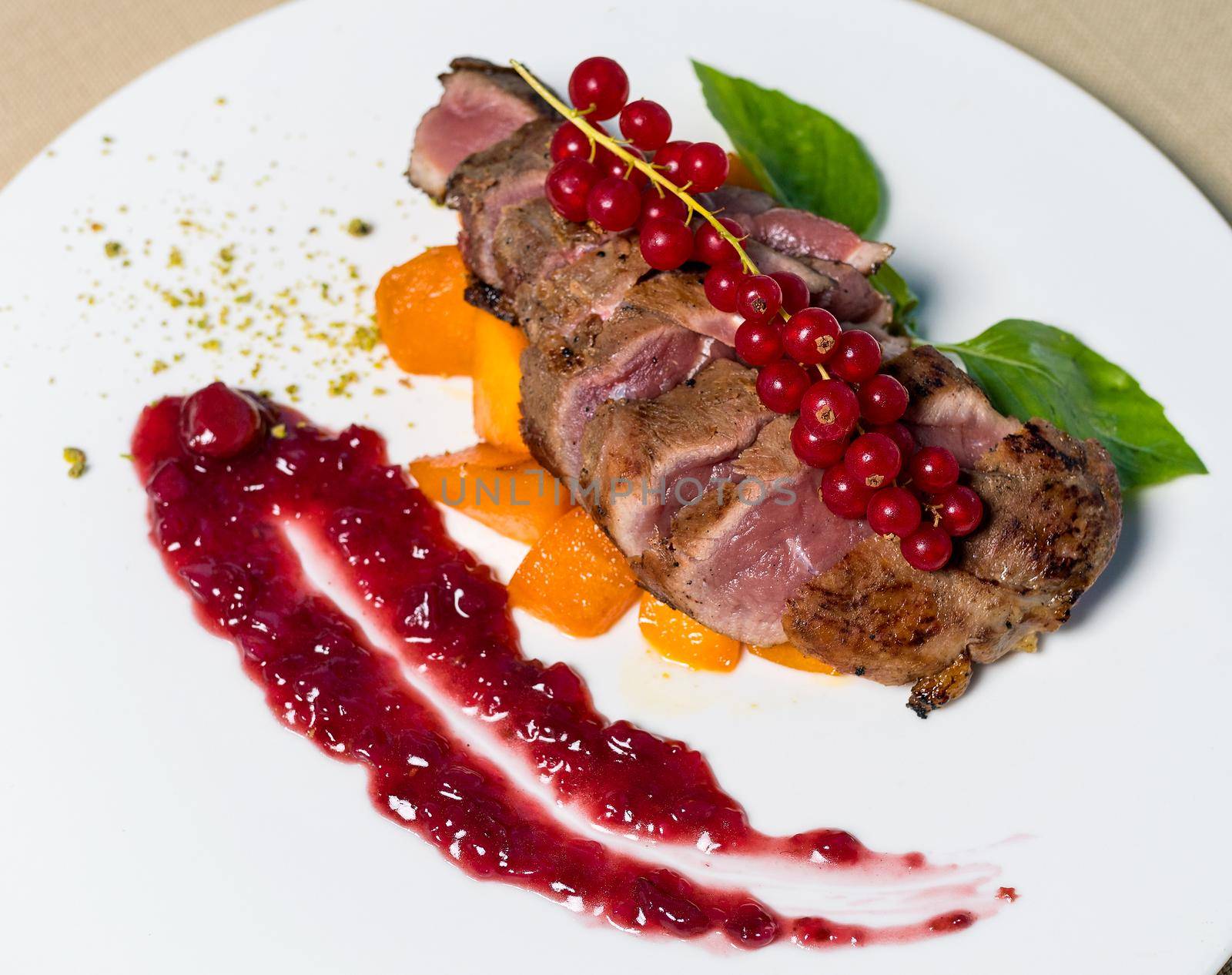 Cooked Steak with Lingonberry on it