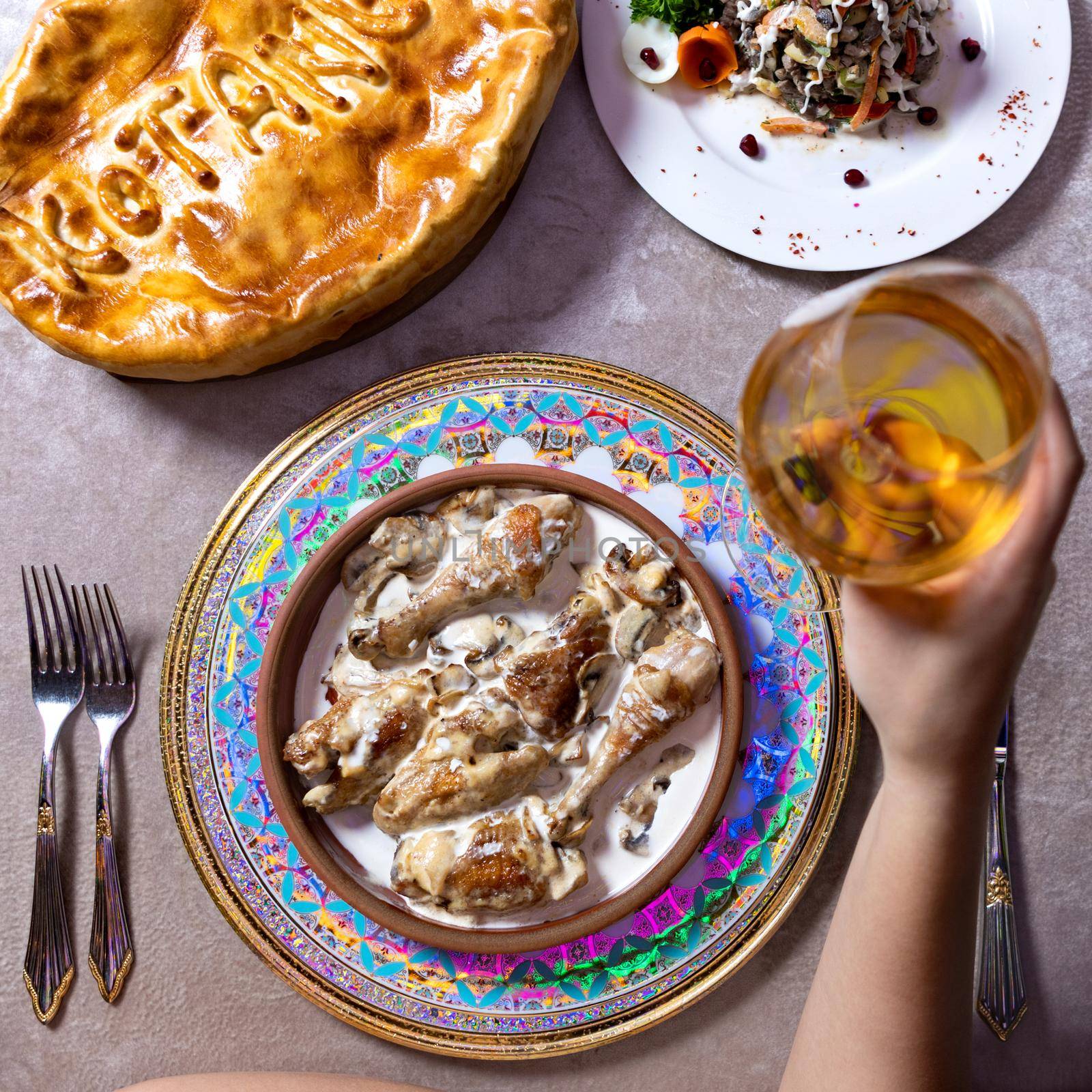 Woman drinking white wine with meat meal, top view