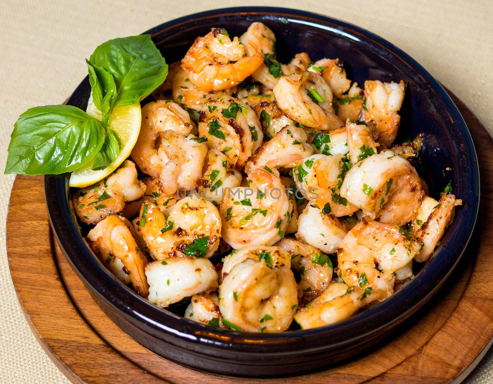 Scampi shrimp meal in the black pot plate close up by ferhad