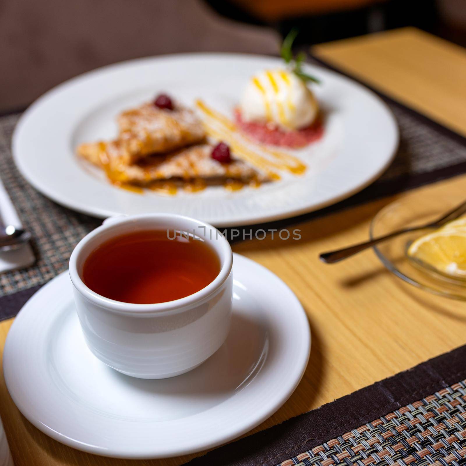 Tasty cake dessert with tea and lemon