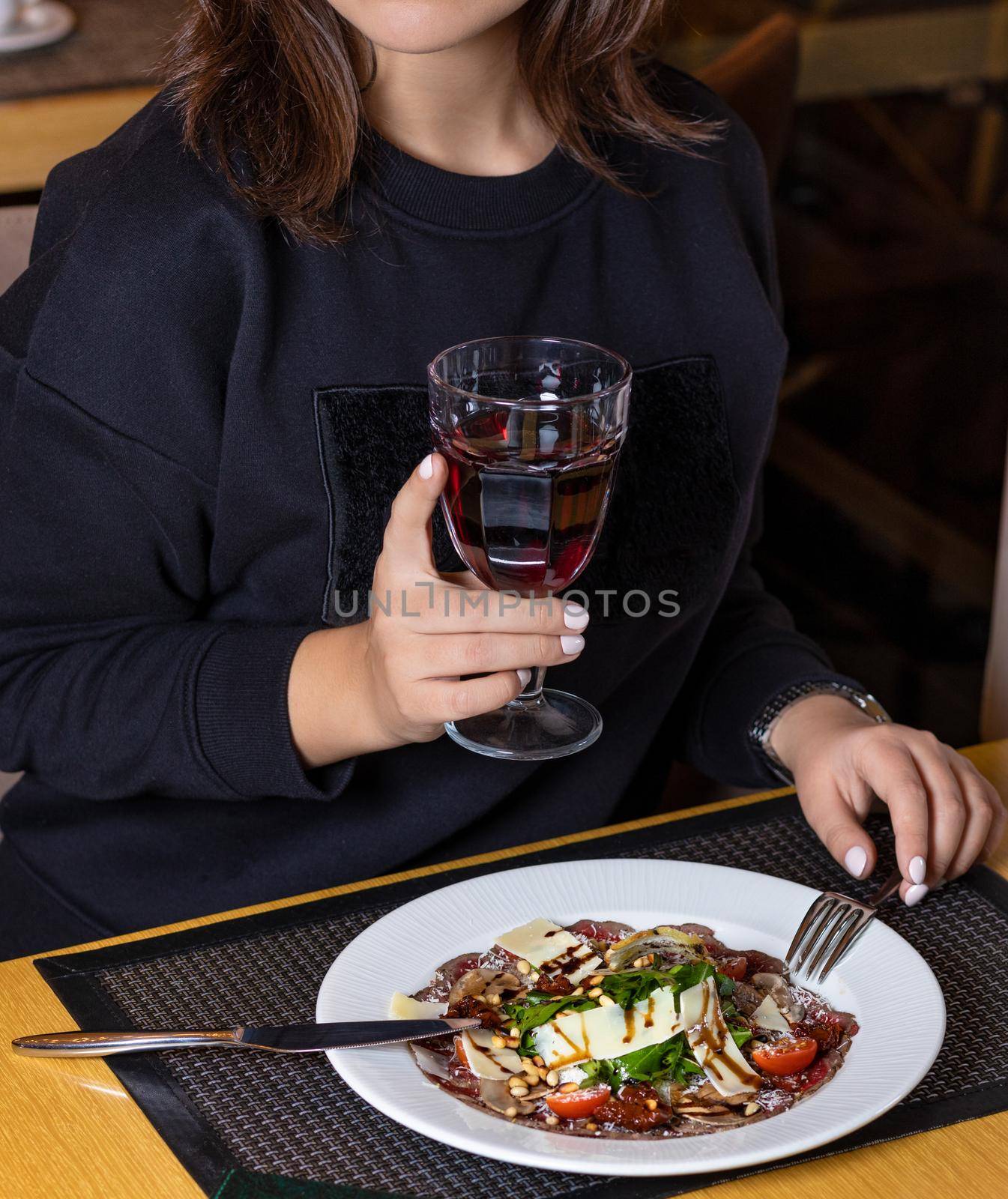 Woman drinking juice with fish salad