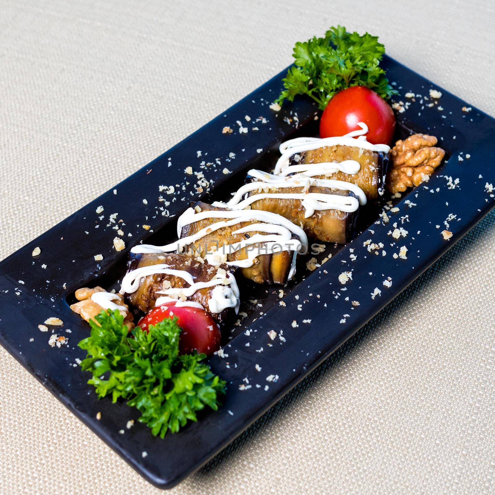 Eggplant, tomato garnish with sauce close up