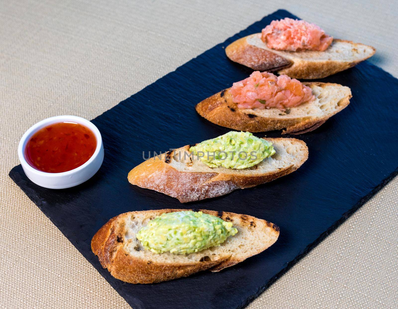 Tasty wasabi on the bread tapas with sauce garnish by ferhad