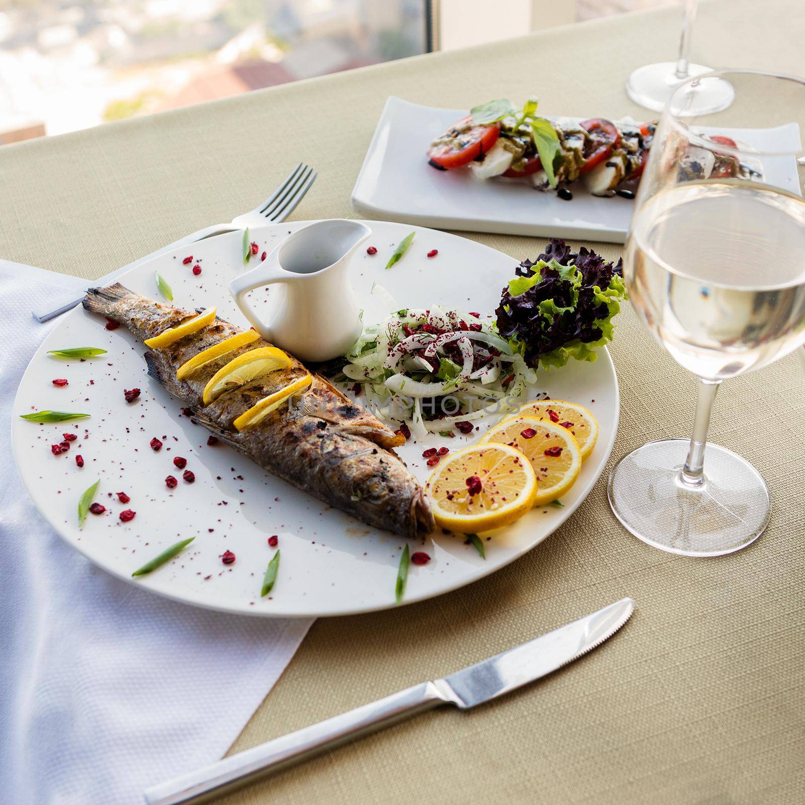 Tasty fish meal with lemon and white wine