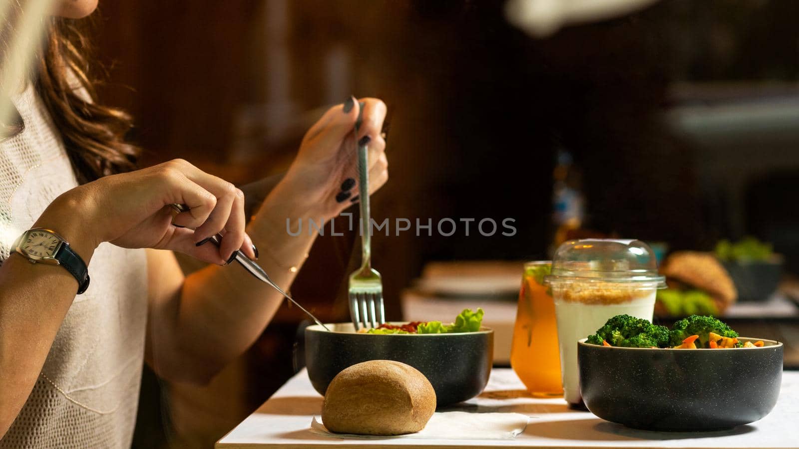 Woman eating tasty chicken salad with dessert by ferhad