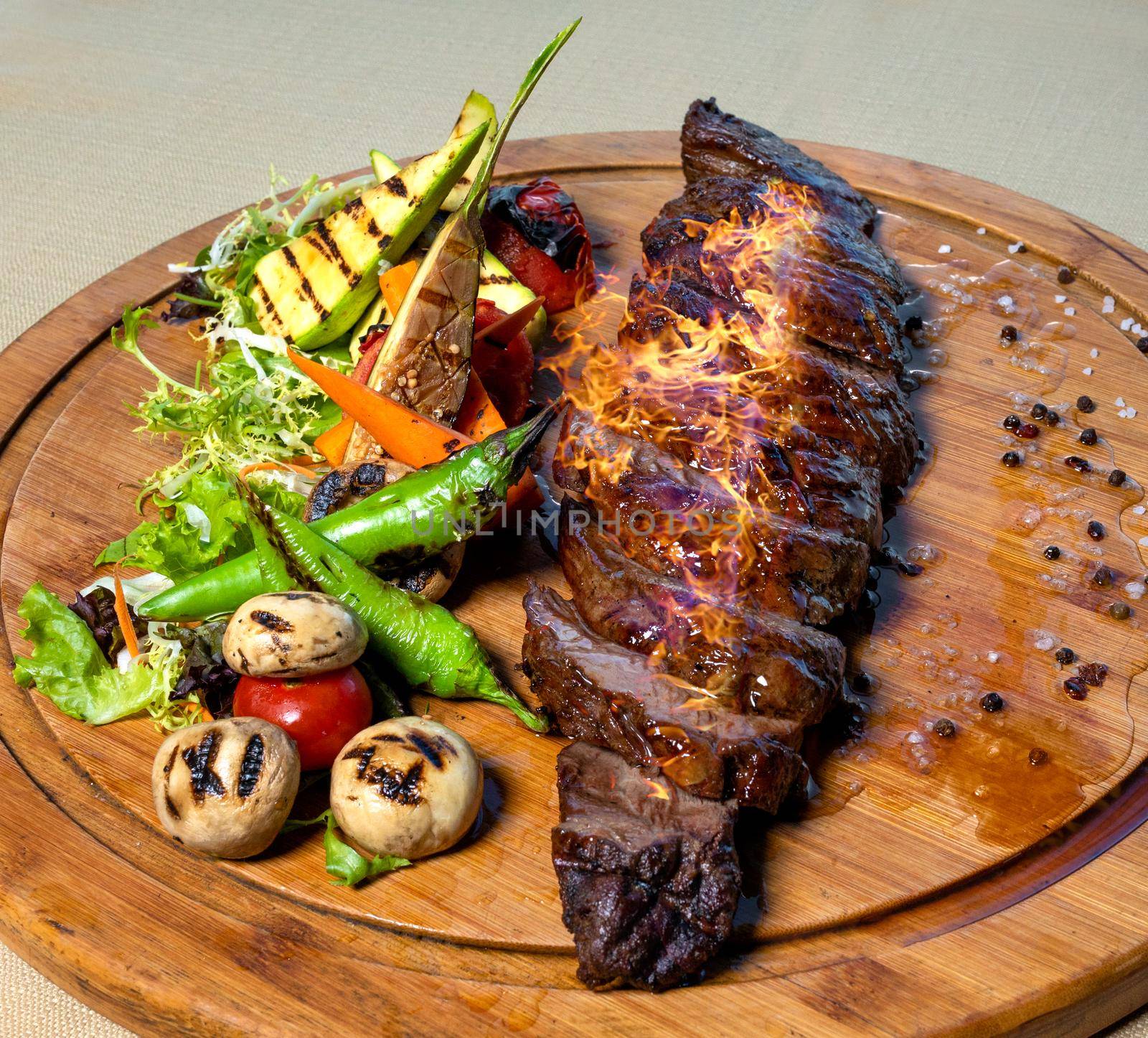Fresh Steak with fire on it, wooden plate by ferhad