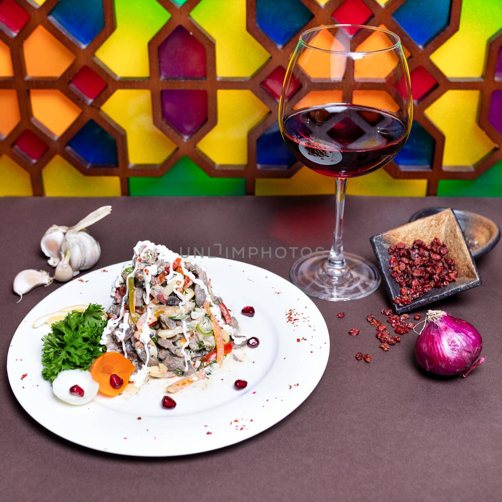 Tasty salad with red wine with colorful background