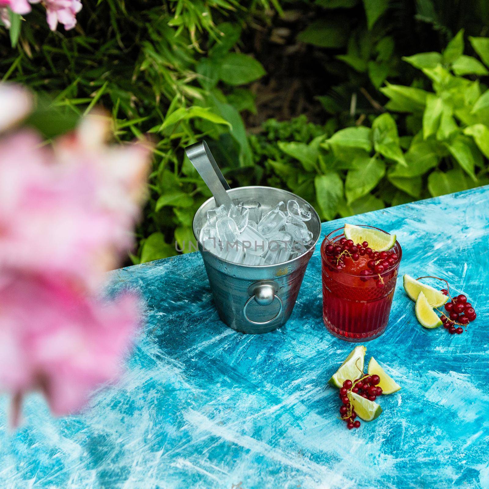 Lingonberry fruit with lime and ice in bucket