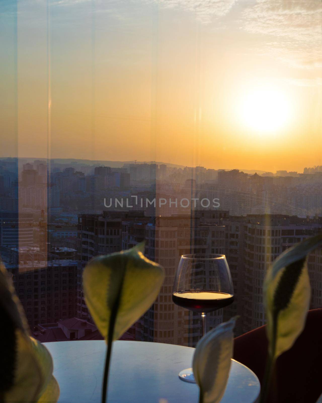 Red wine glass with city view, sunset view by ferhad