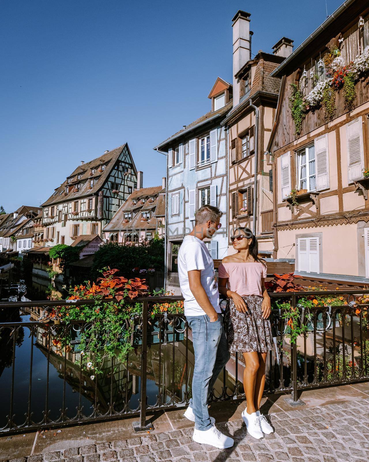 couple on city trip Colmar, Alsace, France. Petite Venice, water canal and traditional half timbered houses. Colmar is a charming town in Alsace, France. Beautiful view of colorful romantic city Colmar, France, Alsace by fokkebok