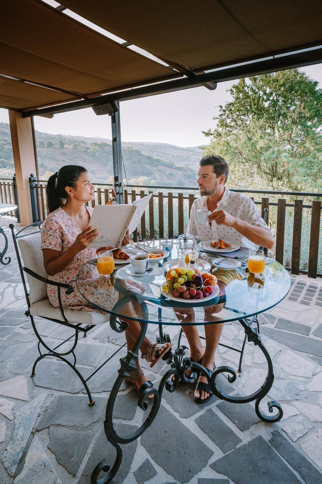 couple having breakfast at luxury villa at the Italian country side near Rome Italy by fokkebok