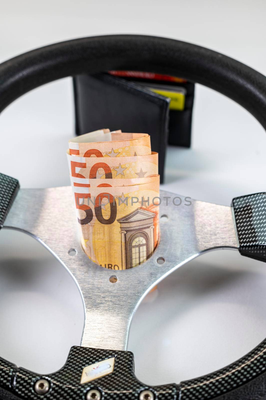 sport racing steering wheel with 50 euro banknotes with white background
