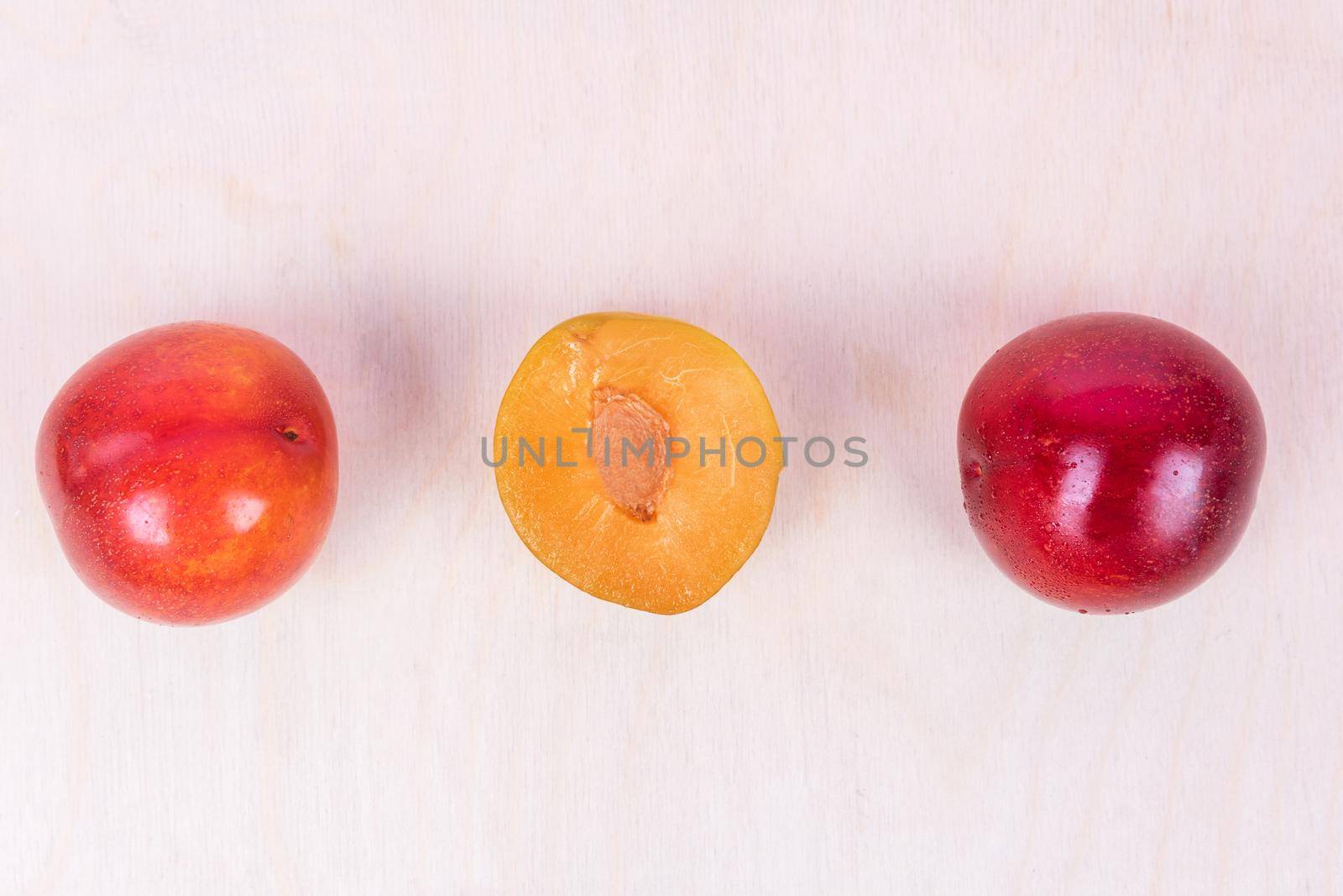 Red and yellow plum fruit on the white background isolated top view by ferhad