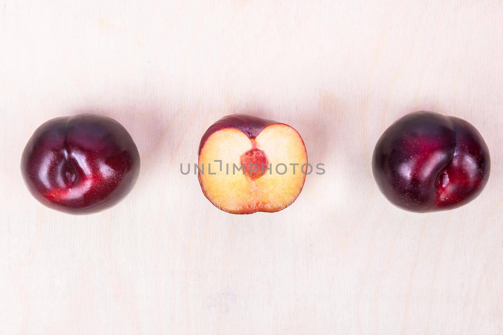 Red plum fruit on the white background isolated top view by ferhad
