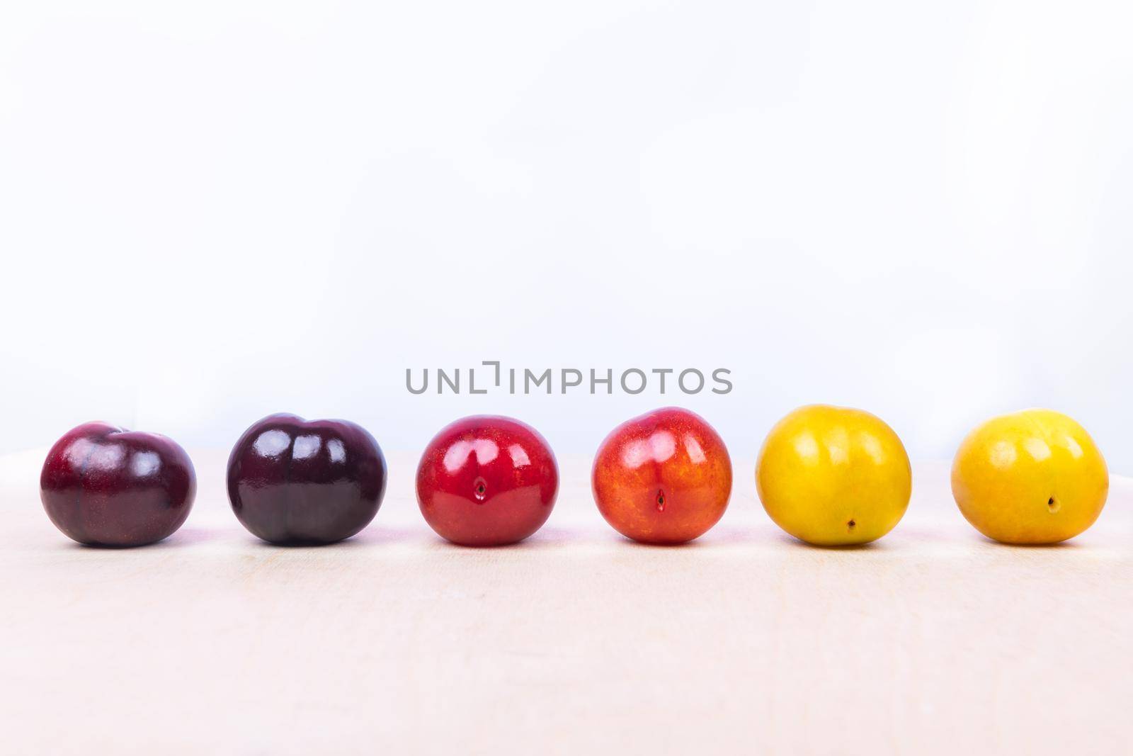 Red, yellow plum fruit close up on the white background isolated by ferhad