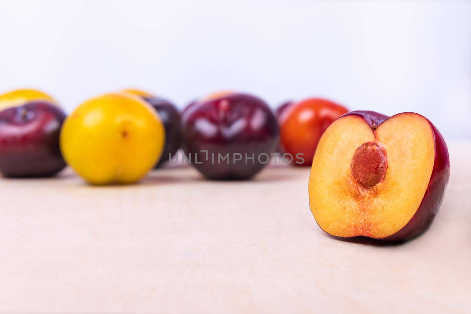 Red, yellow slice plum fruit close up on the white background isolated by ferhad