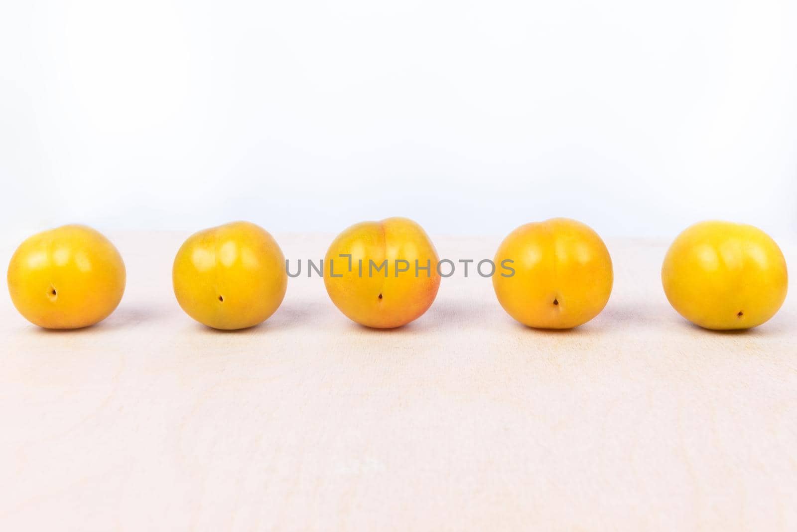Yellow plum fruit on the white background isolated by ferhad