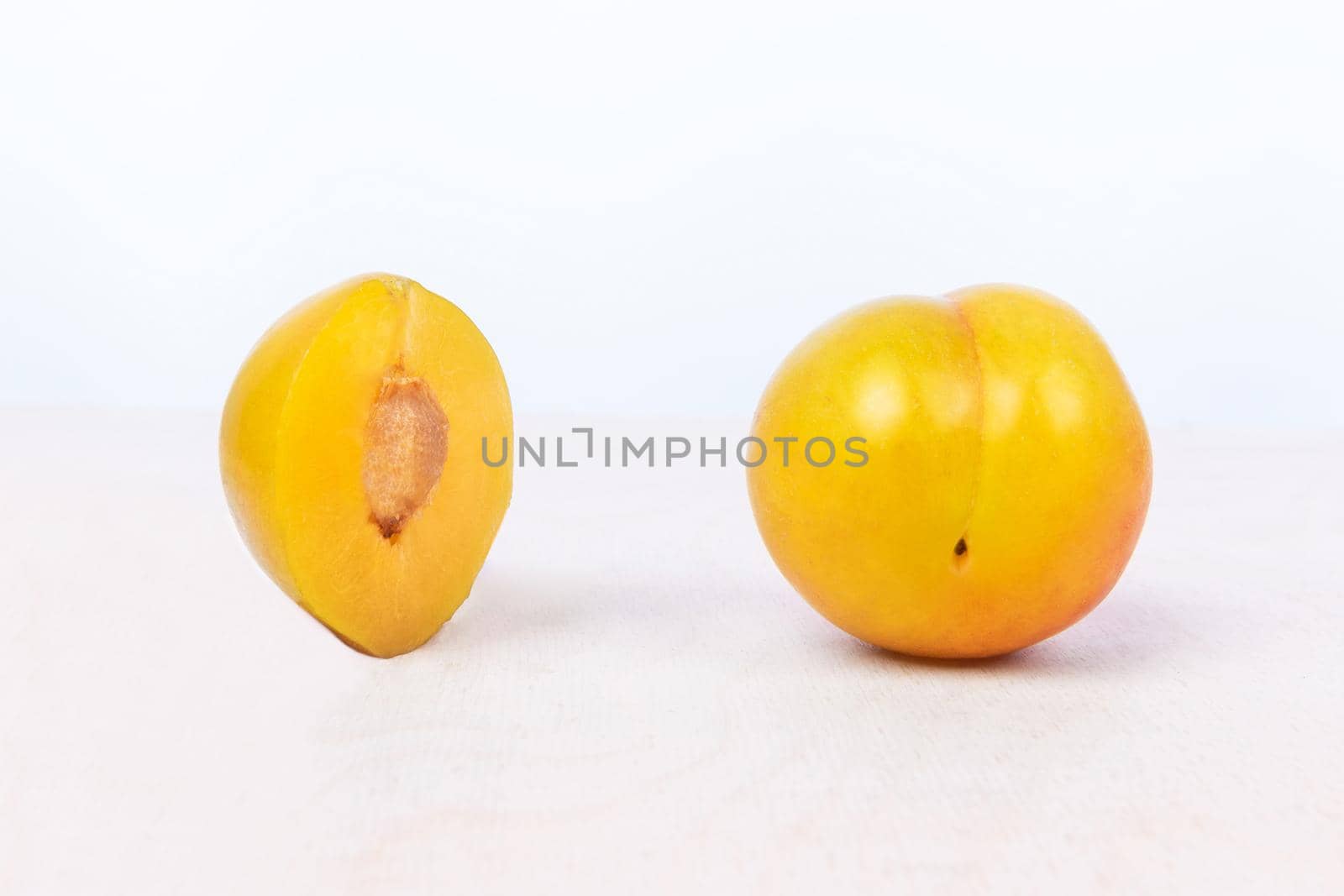 Yellow plum fruit on the white background isolated by ferhad