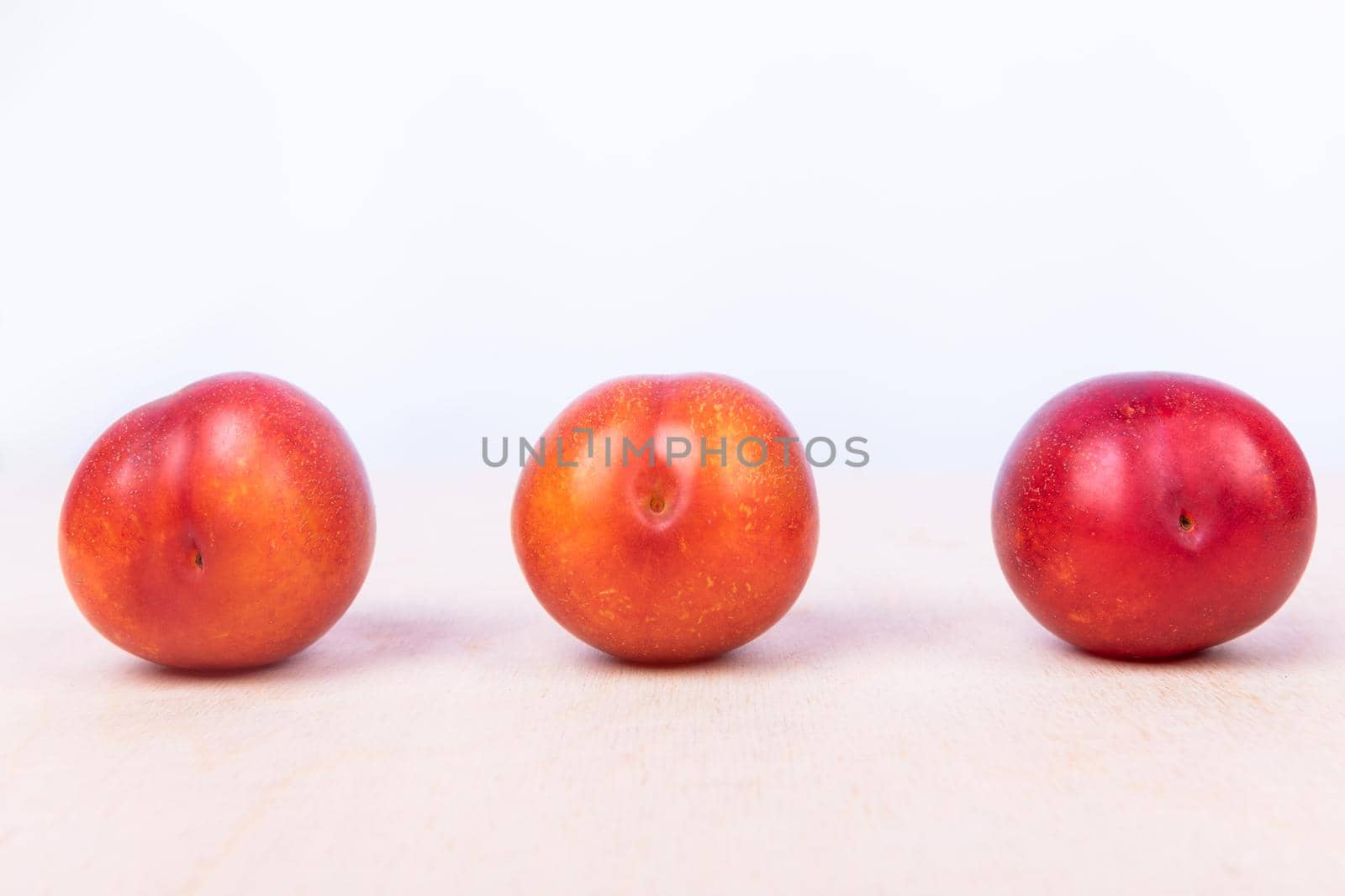 Red plum fruit on the white background isolated