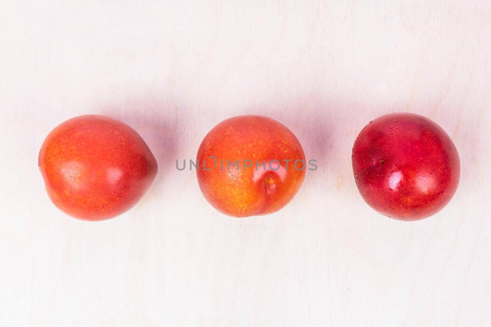 Red plum fruit on the white background isolated top view by ferhad