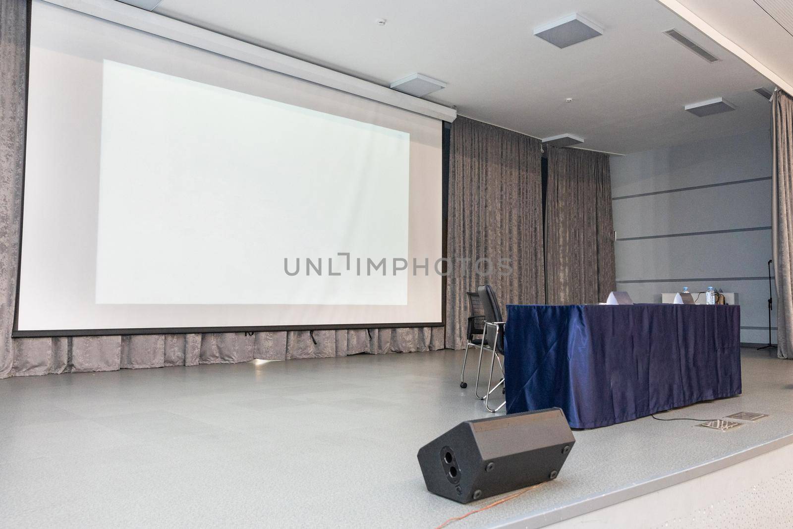 Empty event hall with table and projector