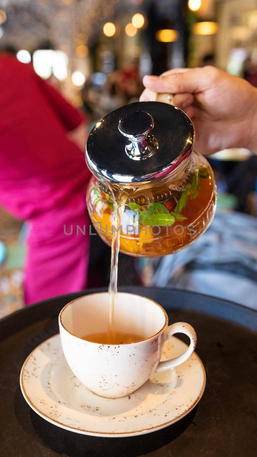Pouring yellow natural tea to the cup by ferhad