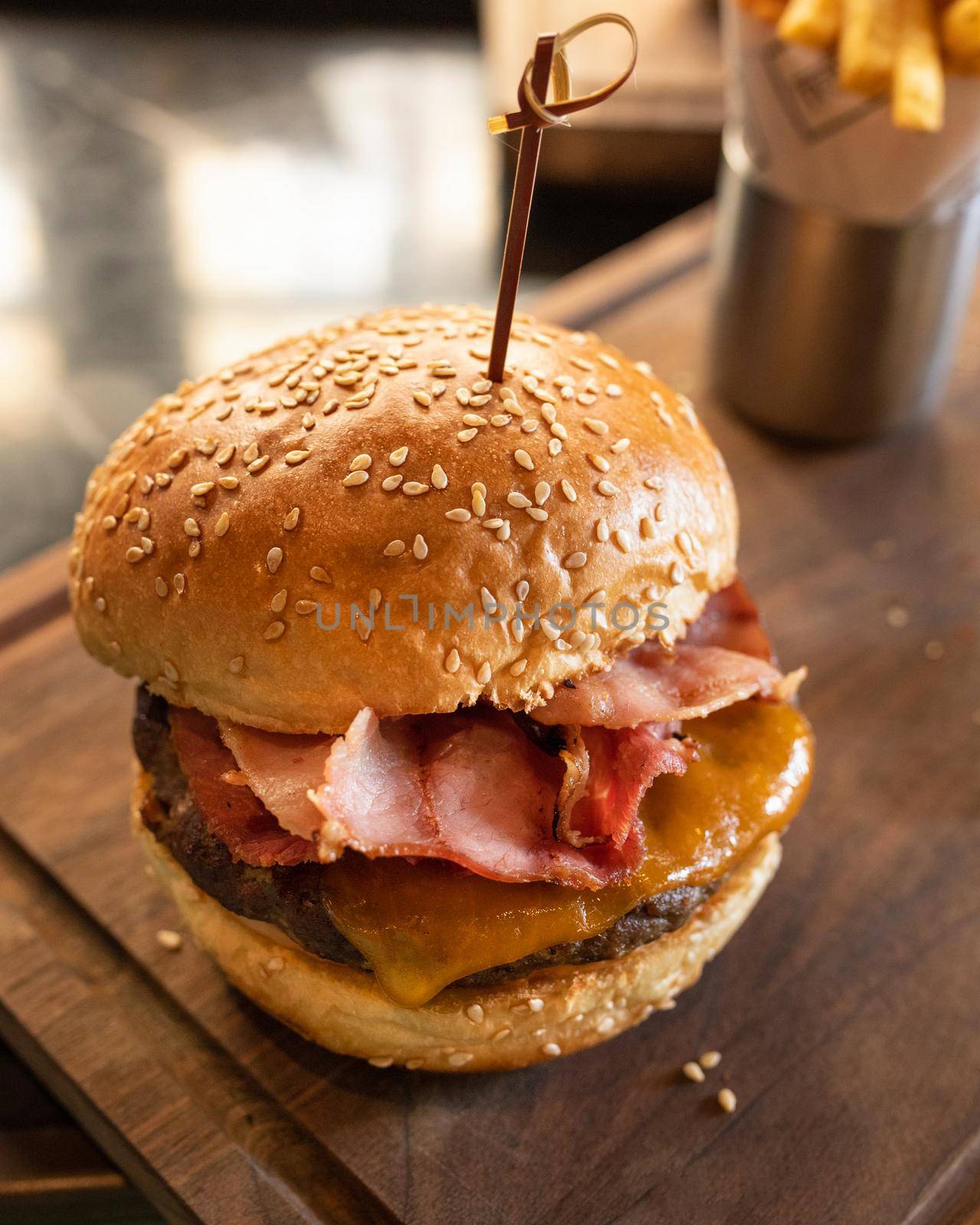 Tasty burger on wooden plate