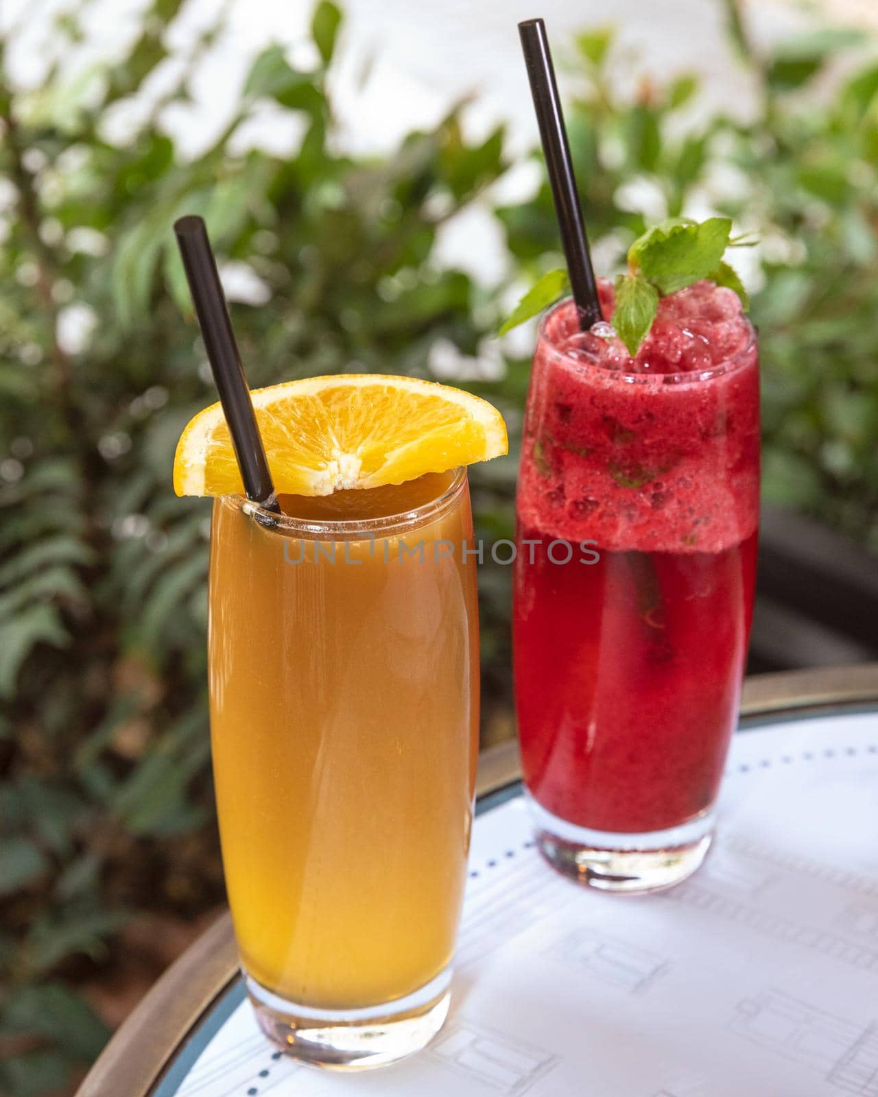 Red fruit cocktail with orange juice close up