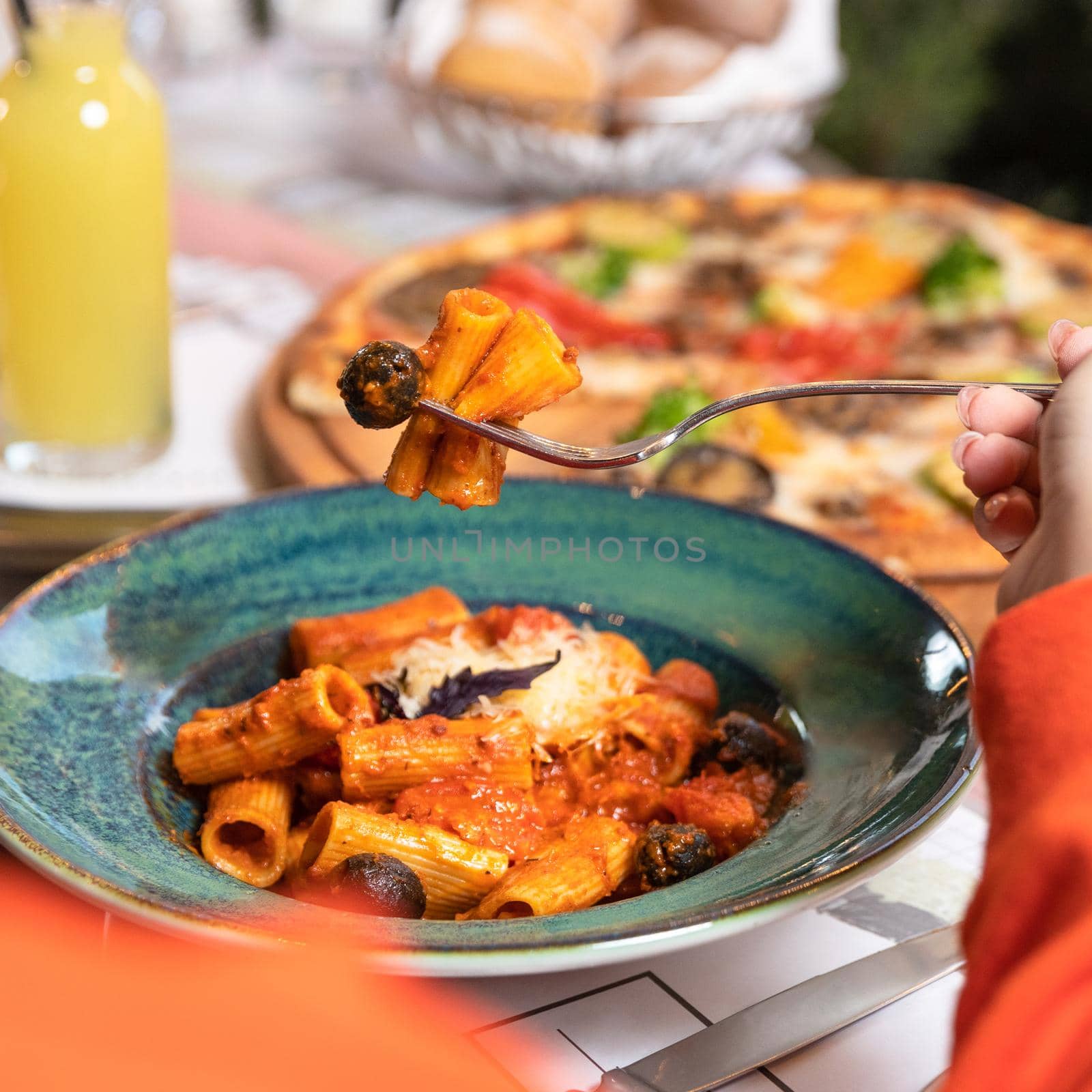 Eating pasta with red sauce close up by ferhad