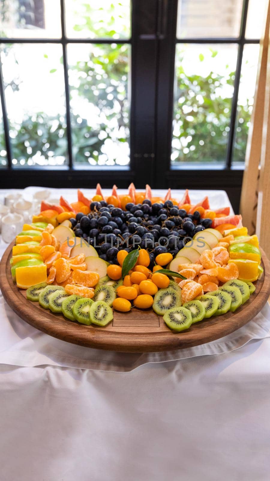 A lot of fruits on the wooden plate by ferhad