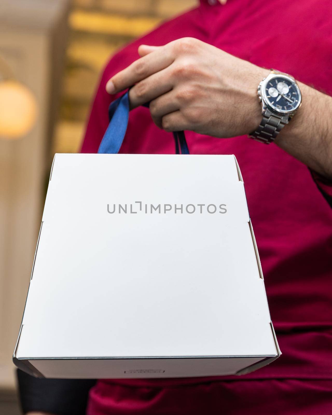 Man holding white box by ferhad
