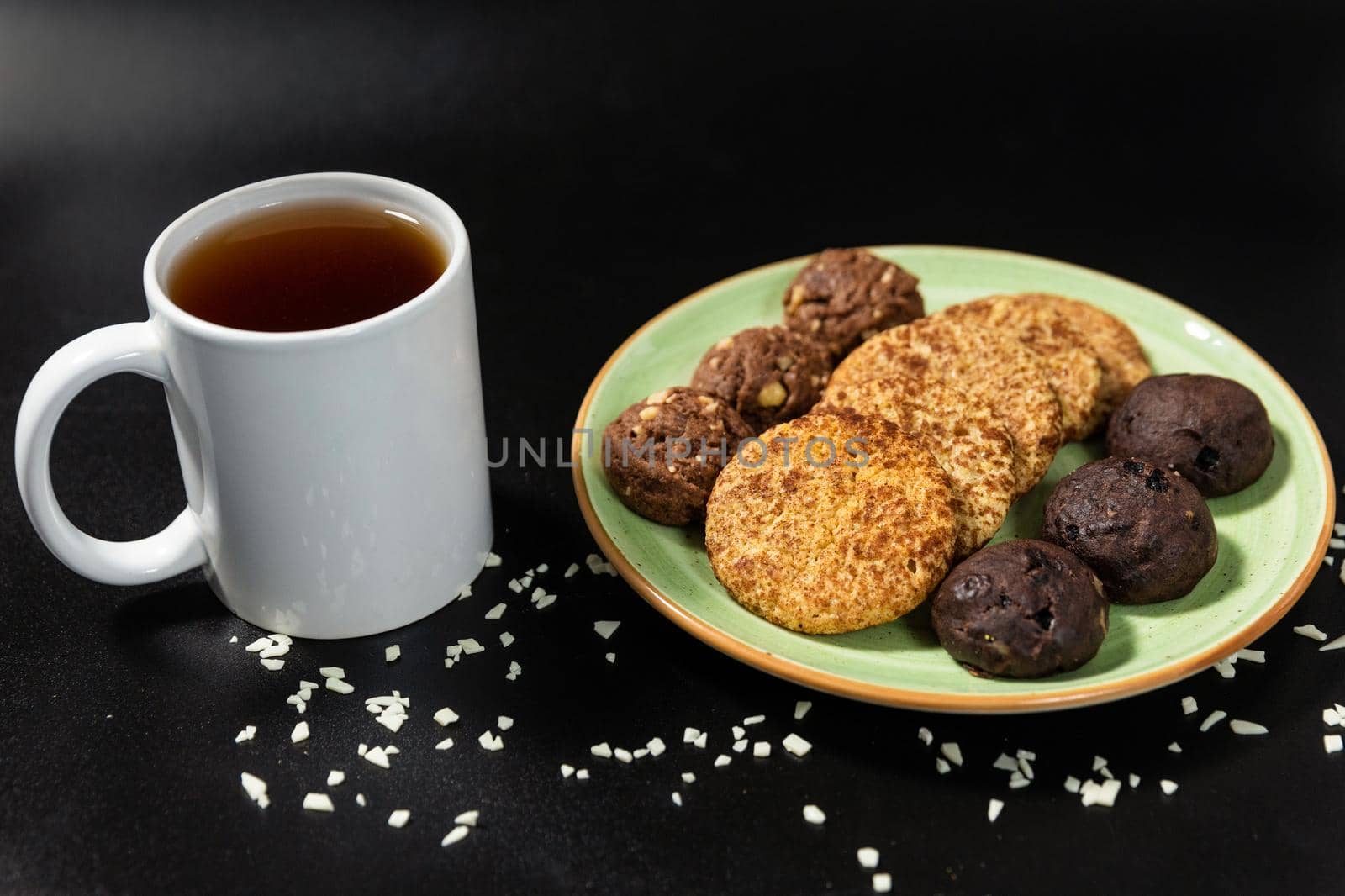 Tasty chocolate cookies with a tea cup on the black background by ferhad
