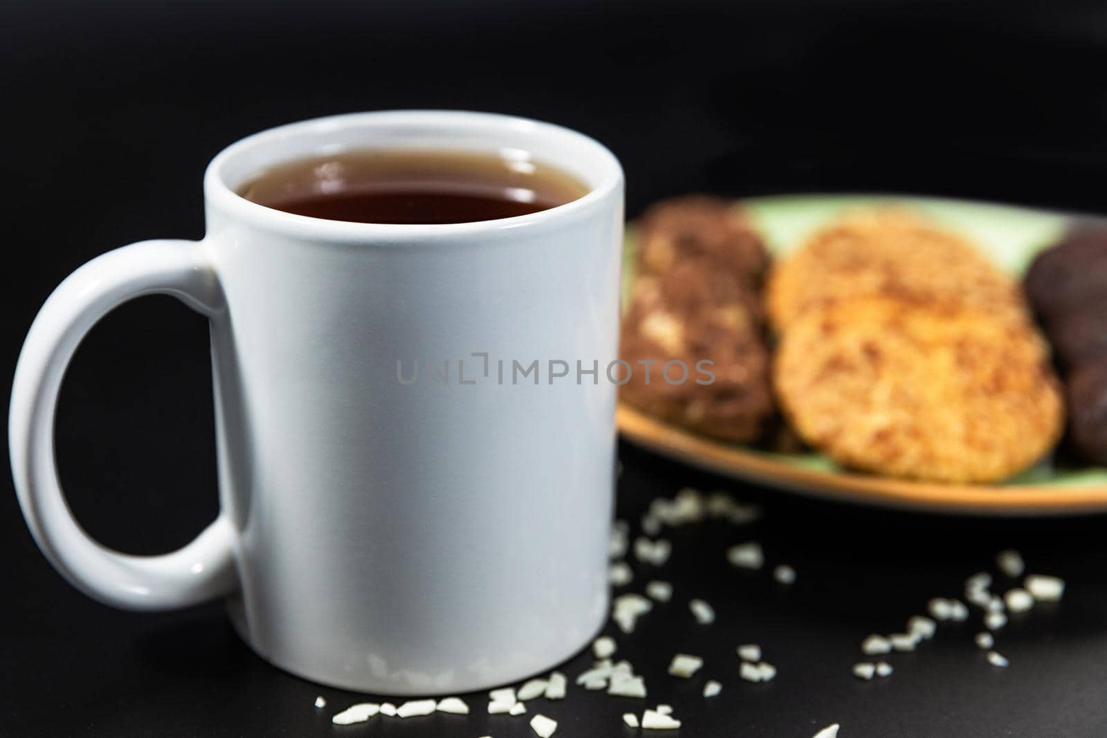 Tasty chocolate cookies with a tea cup on the black background by ferhad