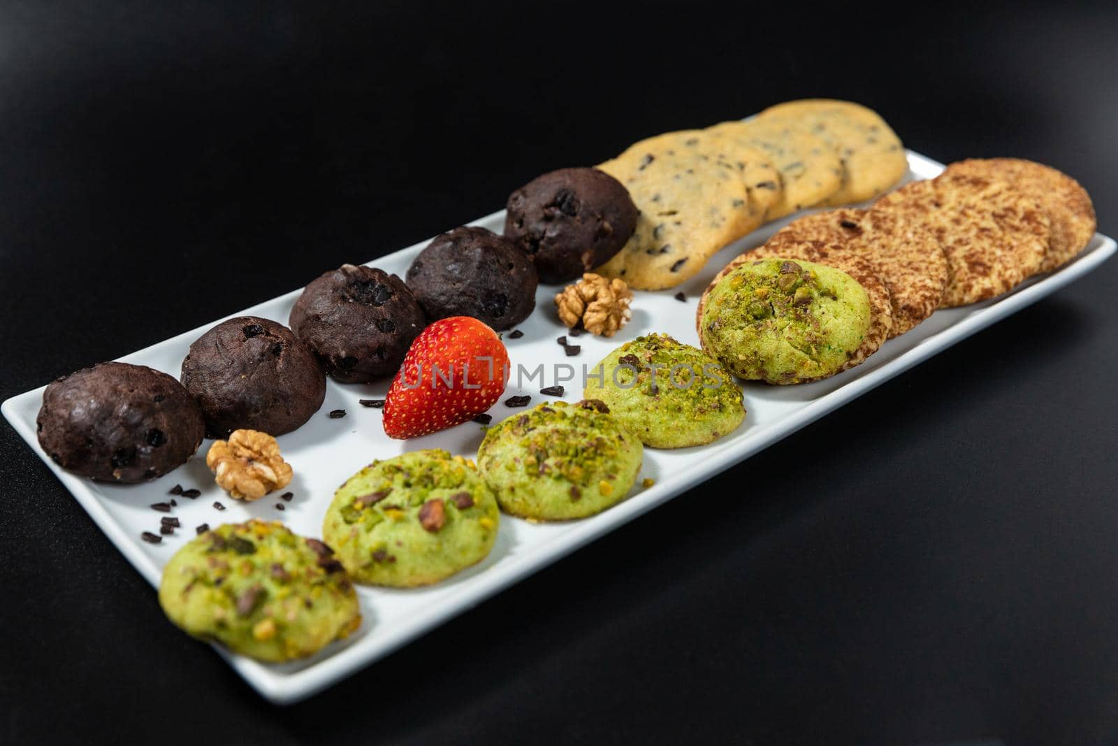 Tasty colorful chocolate cookies on the black background by ferhad