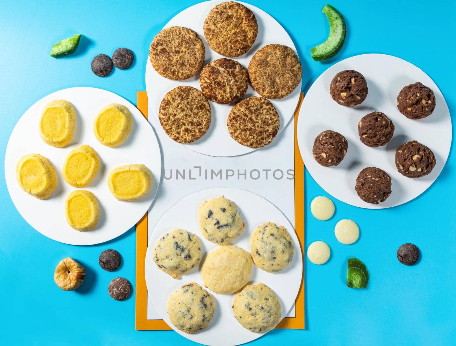 Tasty colorful chocolate cookies on the blue background, top view by ferhad