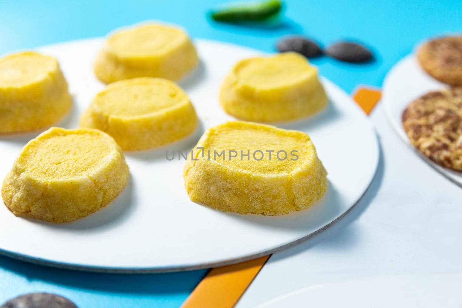 Tasty yellow cookie on the blue background, close up by ferhad