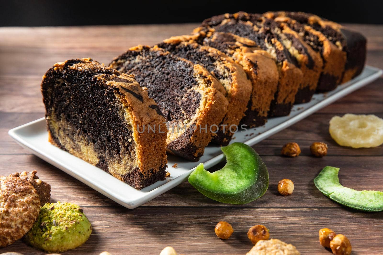 Sweet swiss roll roulette with caramel and cream and milk chocolate shards over it by ferhad
