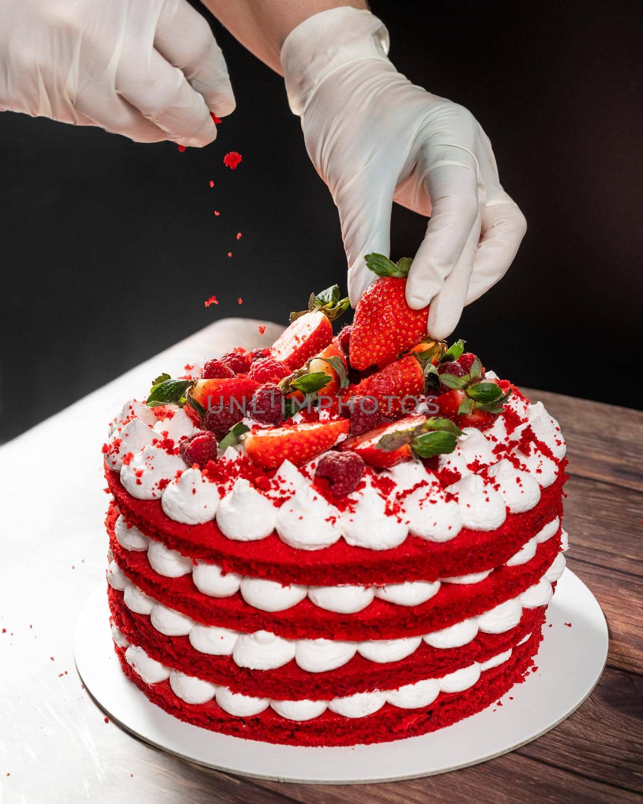 Tasty red strawberry chocolate cake, pouring ingredient