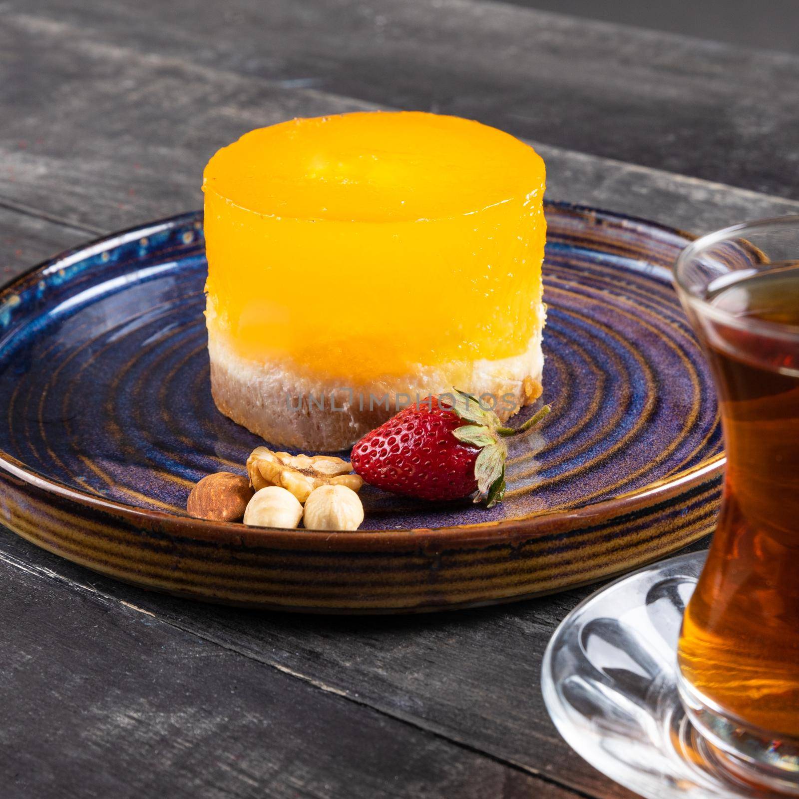 Beautiful yellow dessert with glass of tea by ferhad